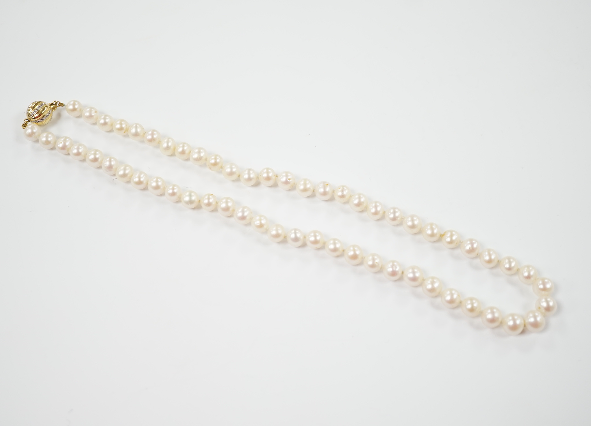 A single strand cultured pearl necklace with 18K and diamond chip set spherical clasp, 49cm.